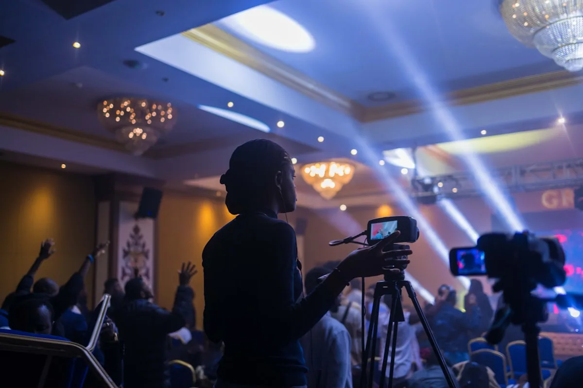 Professional videographer filming at a corporate conference event